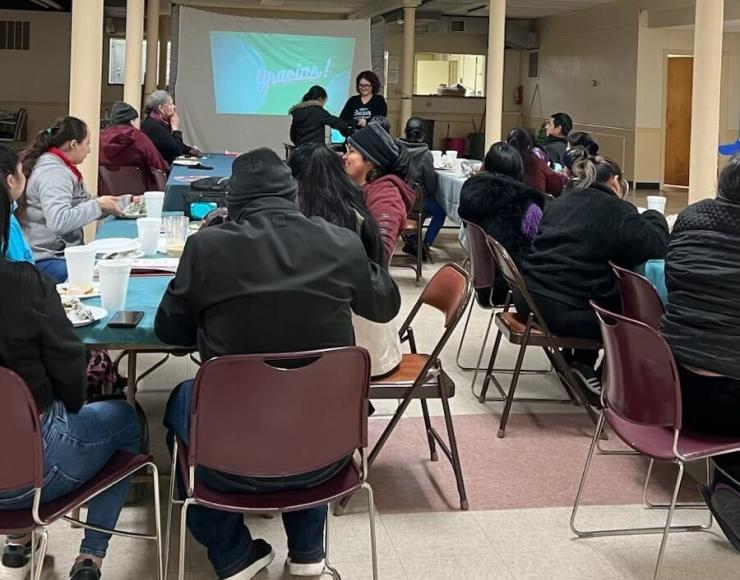 Photo caption: Neighbors enjoy food and community at an energy efficiency workshop co-hosted with Community Engagement Development Center 