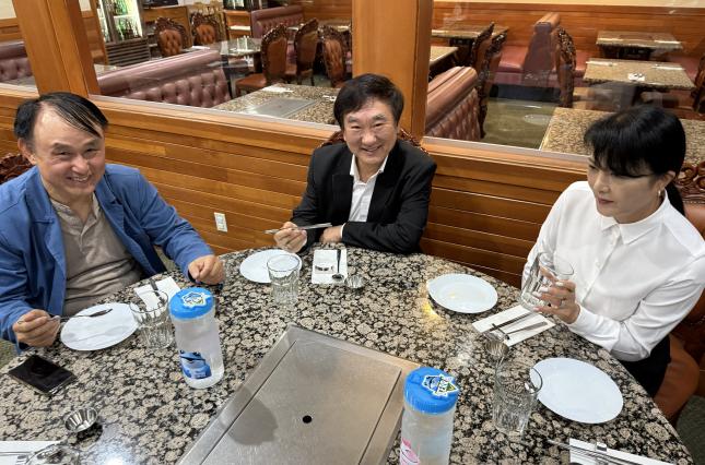 Posing with new reusable items inside the restaurant