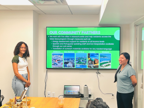 Photo description: Summer interns (Yobenny left, Luisa right) Doing a presentation on MassSAVE