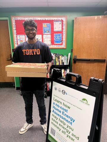 Onkar giving out pizza at the Taunton Mass Save Workshop   