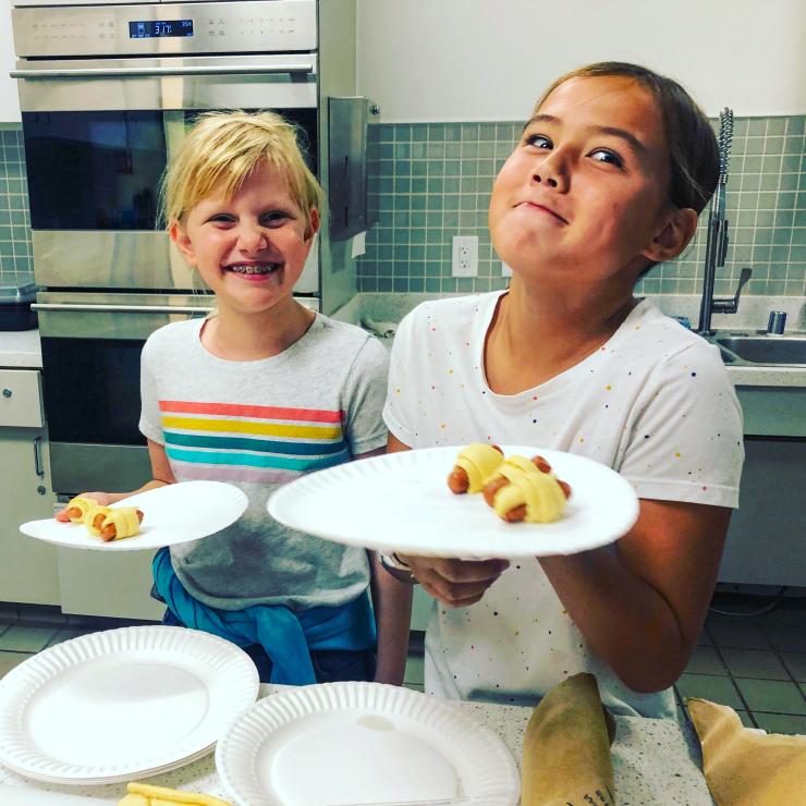 Kids with paper plates before switching to reusable options, San Carlos Youth Center