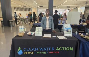 Image of Tolani Taylor at an event table for Climate Week