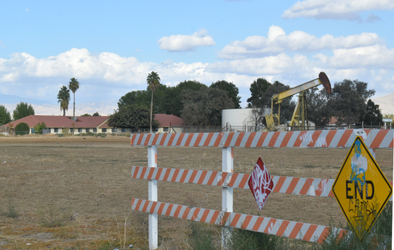 An oil drill located directly next to a family home